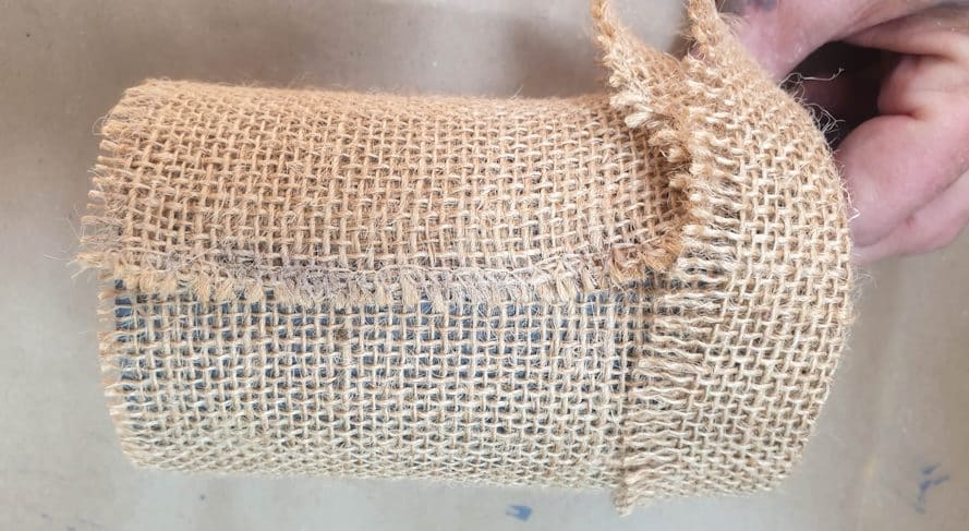 Flip the edge of the burlap or hessian over to form a cuff