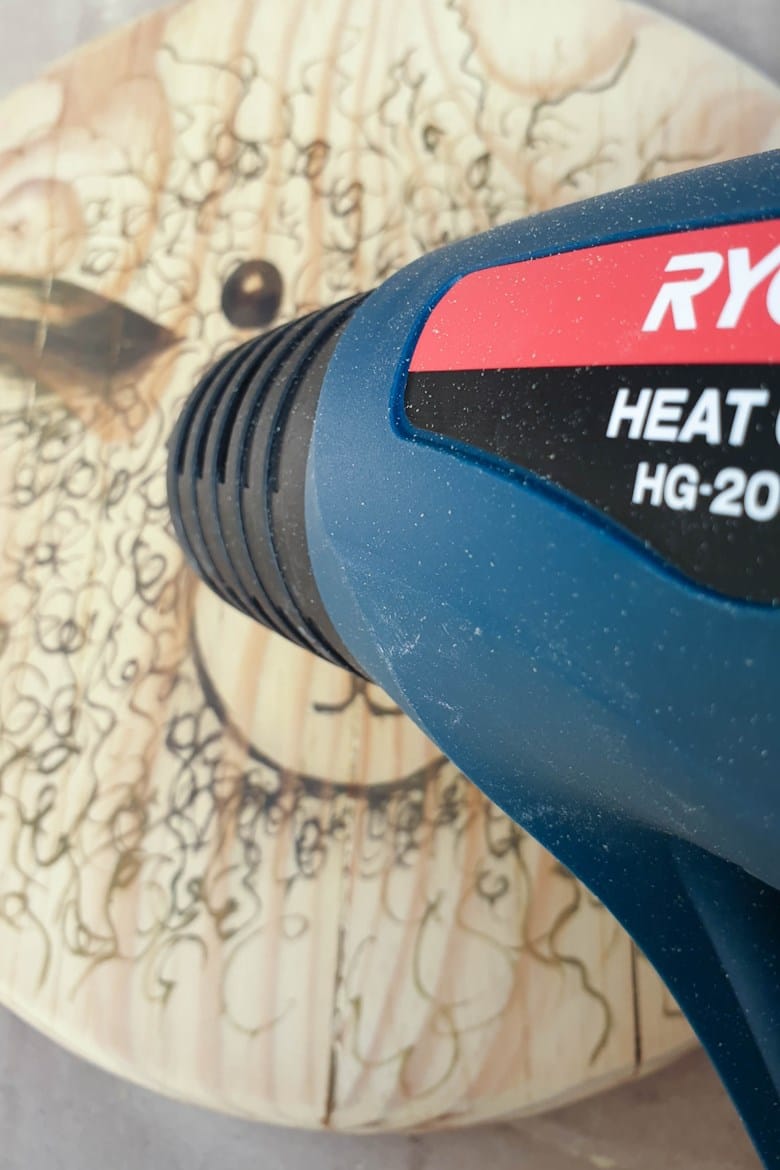 Apply heat to the drawing to activate the chemicals in the scorch pen marker