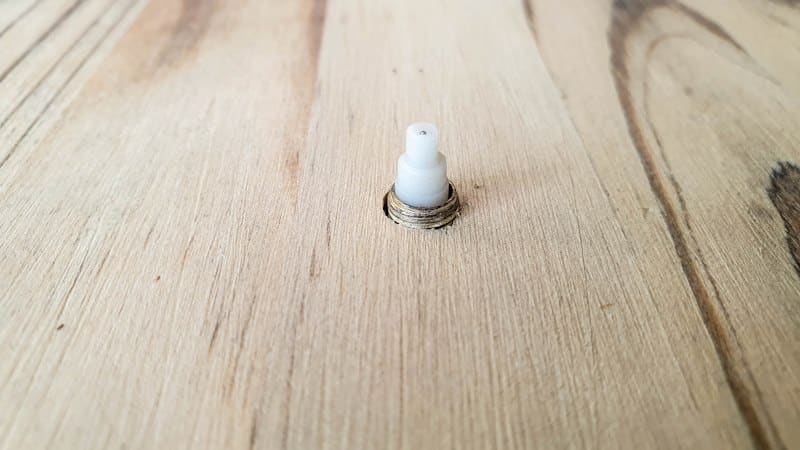 A view of the clock spindle from the front of the scrap wood