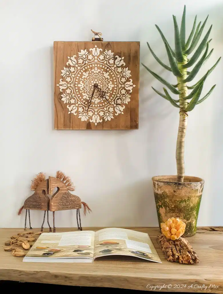 Don’t throw those wood offcuts away until you’ve seen this easy DIY project. We’ll walk you through the steps to repurpose scrap wood to make a unique wall clock with a raised mandala stencil. It’s eco-friendly and will add a timeless and functional boho vibe to your décor. The tutorial will show you how to fit the clock mechanism inside the wood and add a stencil full of texture and interest.
