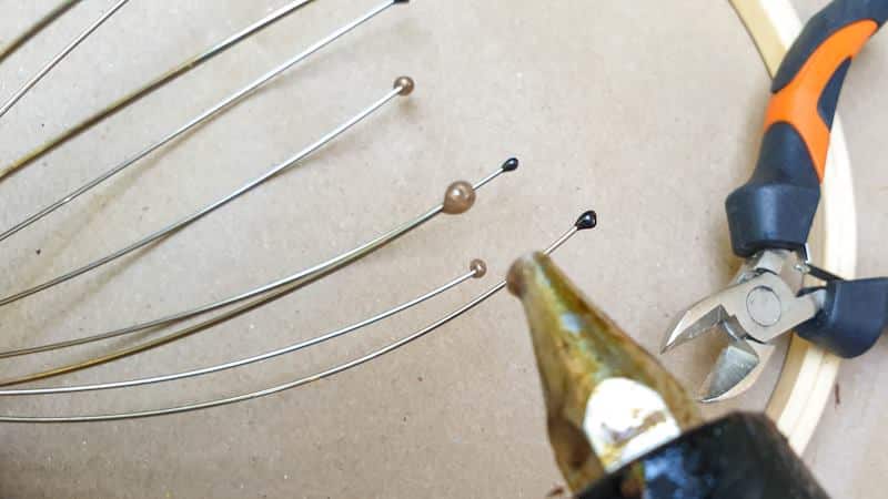 Put glue dots on the ends of the wire after cutting