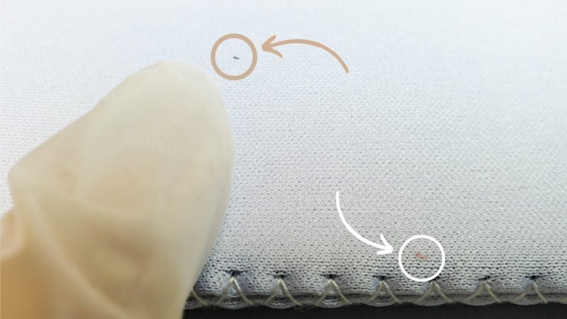 Use sticky tape or a lint free roller to remove any fuzzy bits or dirt