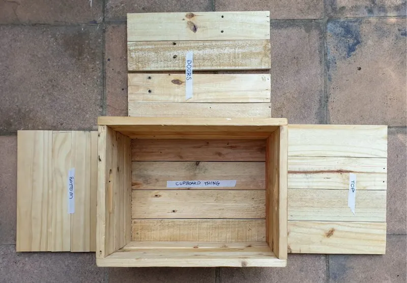 A view from the top of all the cut pieces for the side table along with the crate.