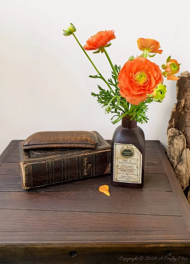 Repurpose a crate to make a rustic side table and give your space a unique, creative makeover. This DIY project is a perfect way to add a touch of vintage charm to your home and create extra storage at the same time. The free tutorial will guide you through the whole process. As an added bonus, we’ll show you how to make faux metal hinges using cardboard and create custom door pulls.