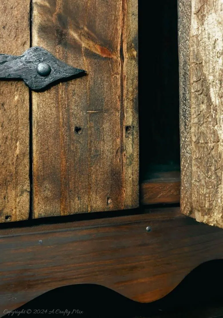 Repurpose a crate to make a rustic side table and give your space a unique, creative makeover. This DIY project is a perfect way to add a touch of vintage charm to your home and create extra storage at the same time. The free tutorial will guide you through the whole process. As an added bonus, we’ll show you how to make faux metal hinges using cardboard and create custom door pulls.