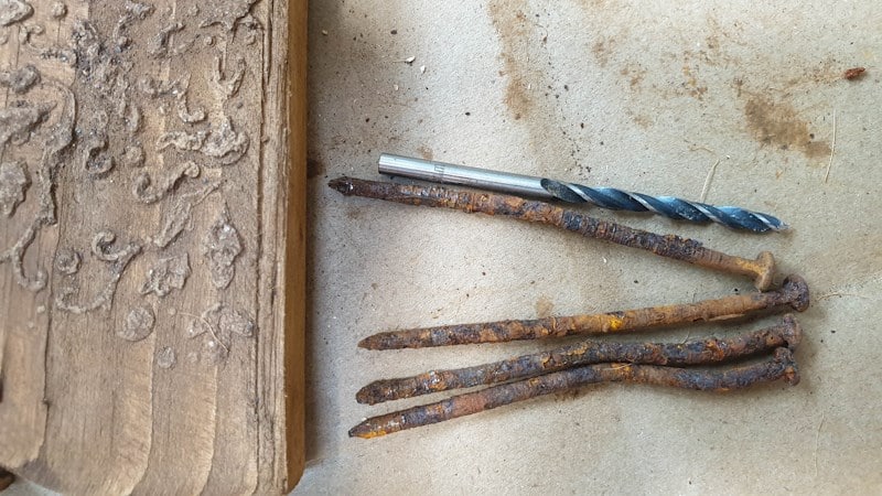 Find rusty nails that are roughly the same height. Use a drill bit that the same diameter as the nails