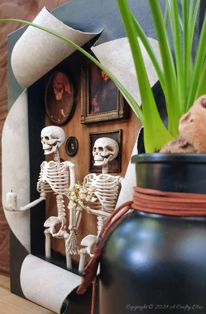 Get your spook on and add a touch of macabre whimsy to your d&eacute;cor with this DIY Halloween RIPped canvas tutorial. It even lights up. We&rsquo;ll show you how to turn a deep canvas into an eerie masterpiece using paint, paste and two loving skeletons. Oh, be warned; we will be cutting, slicing, and mangling things up a little to make this haunting diorama.