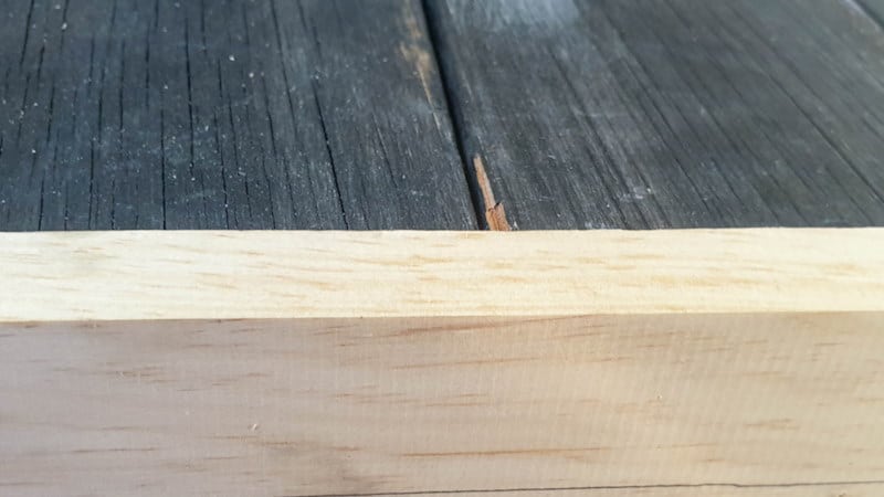 Add trim around the salvaged door to hide the tongue and grooves and bulk it up