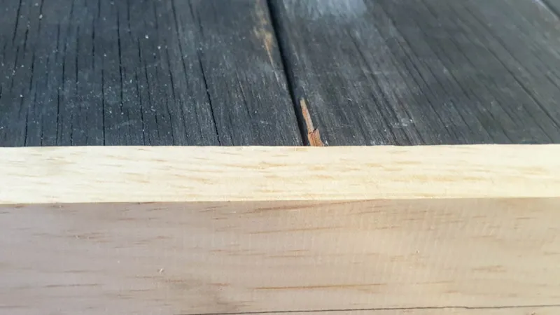 Add trim around the salvaged door to hide the tongue and grooves and bulk it up