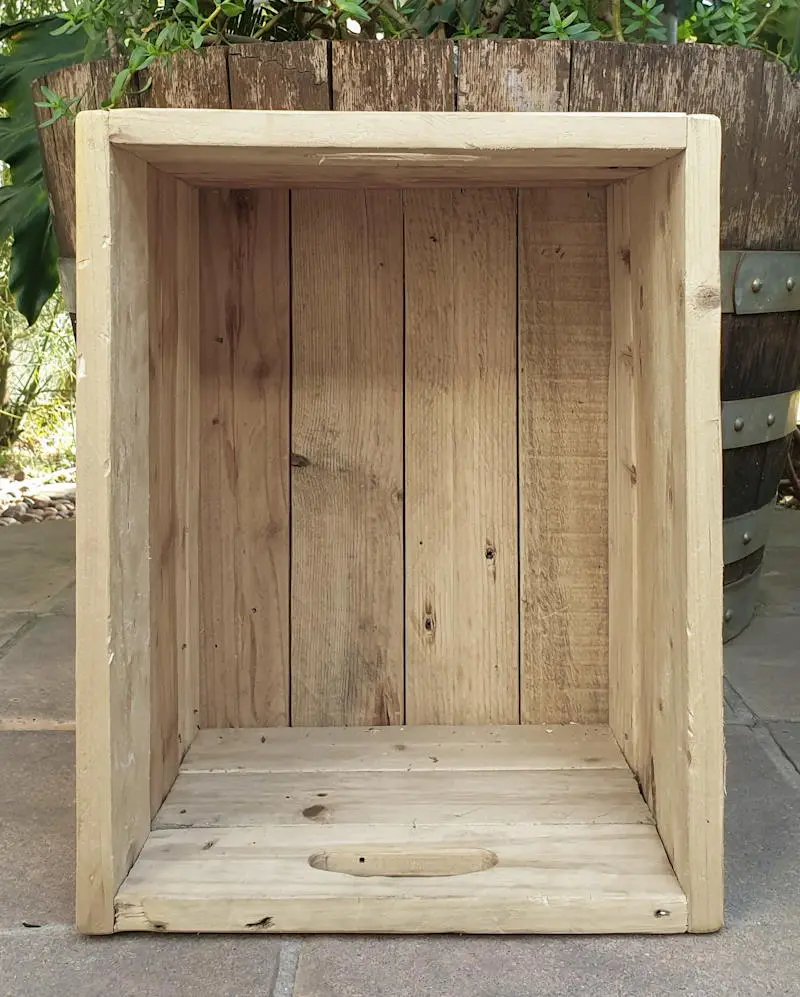 A plain wooden crate that will be transformed into a small cabinet