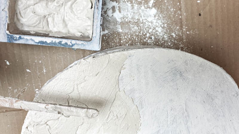 Apply the texture paste with your fingers or a craft stick