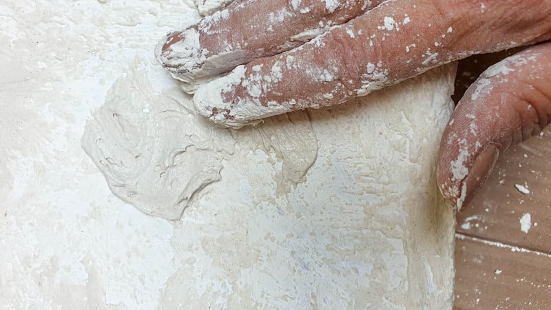Apply the texture paste with your fingers or a craft stick