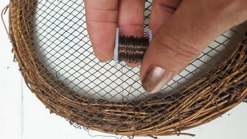 Use florist wire to "sew" the mesh to the wreath