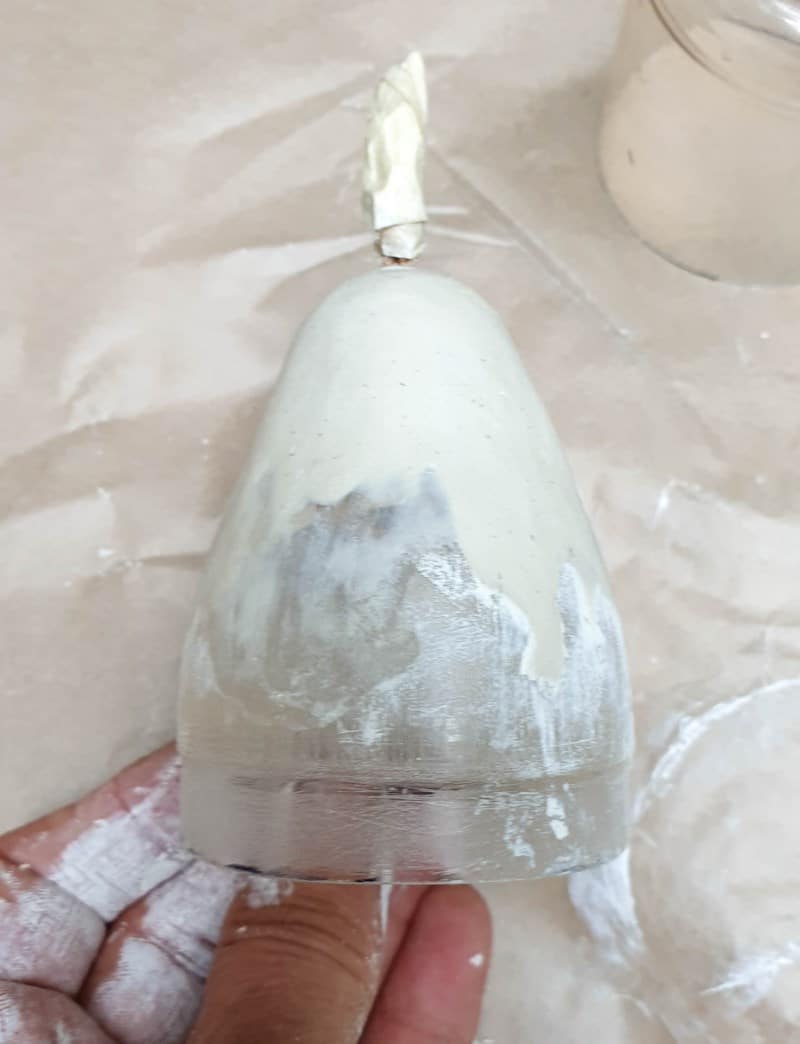 Cover the ball with clay and smooth out