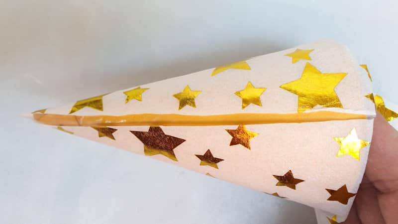 Wrap the napkin around the cone and trim away any overlap