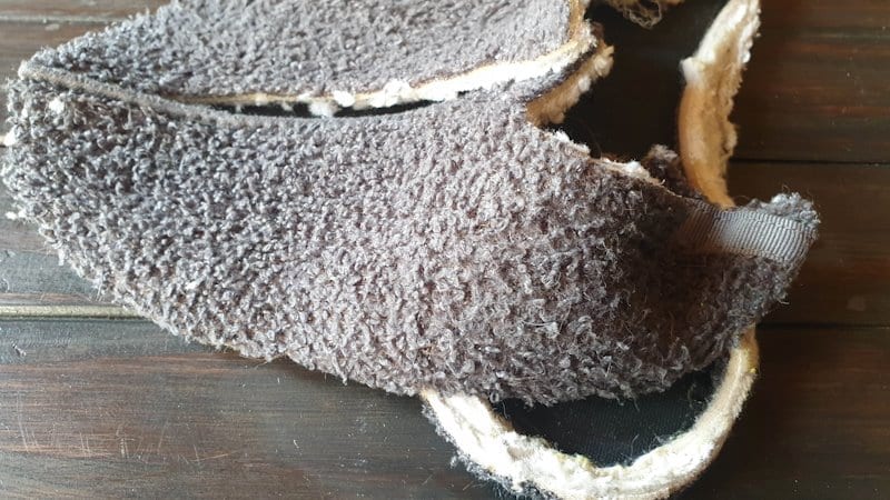 Cutting up a chewed slipper to make the plushie ears