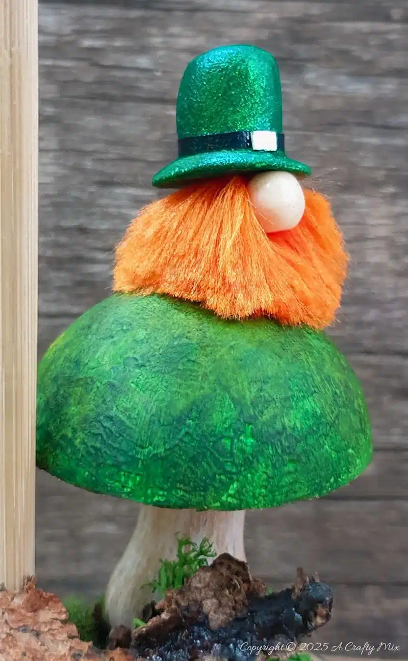 Have we got a fun, festive craft idea to bring a touch of Irish charm to our decor! I’ll show you how to make these St. Patrick's Day place cardholders with little leprechauns, a polystyrene ball mushroom, and a signpost. Not only will these adorable little accents add a pop of color to your table, but they're super simple to make too.
