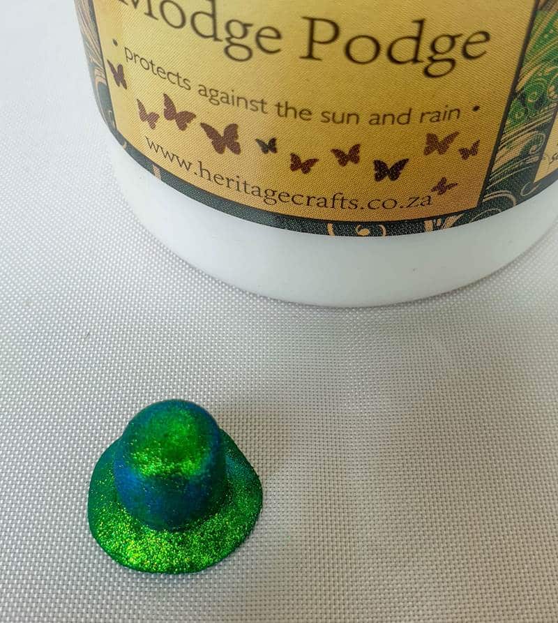 Seal the clay leprechaun hats with Mod Podge