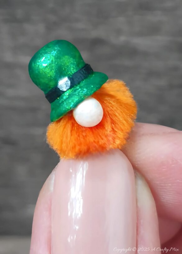 Have we got a fun, festive craft idea to bring a touch of Irish charm to our decor! I’ll show you how to make these St. Patrick's Day place cardholders with little leprechauns, a polystyrene ball mushroom, and a signpost. Not only will these adorable little accents add a pop of color to your table, but they're super simple to make too.
