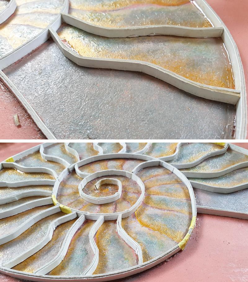 Use the thin strips of cardboard to create the ammonite's septa