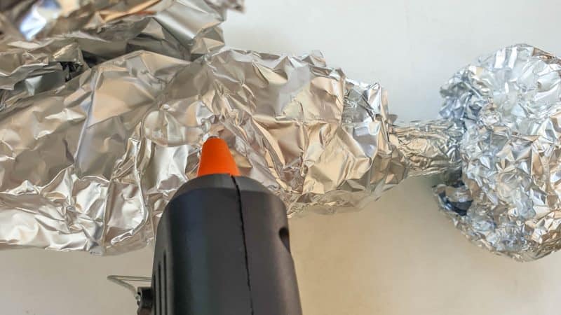 Build up layers of foil around the dowel