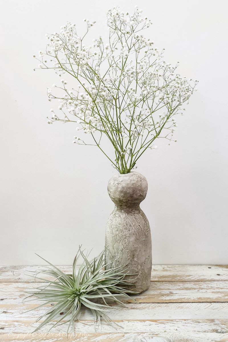 Make a delightful faux concrete bunny vase in under an hour using stuff you probably have lying around. This easy Easter craft is perfect for adding a touch of rustic elegance to your home decor. Use it to display long leaves for bunny ears or fill it with flowers for a beautiful centerpiece. It's a fun and creative way to welcome spring.