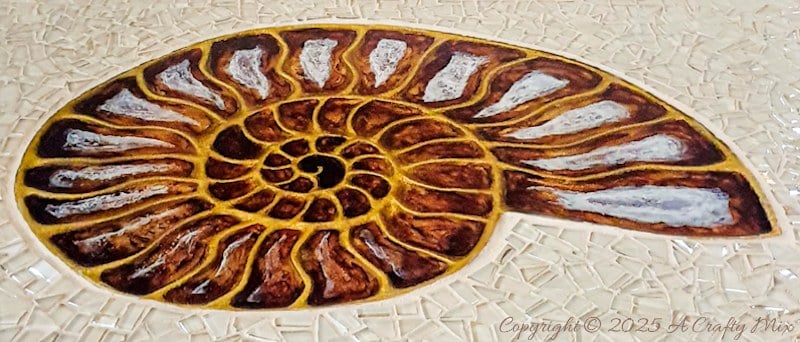 Looking for a unique way to breathe new life into an old piece of furniture? We&rsquo;ll show you how we gave a water-damaged tabletop a gorgeous &ldquo;mosaic and ammonite inlay&rdquo; makeover. This comprehensive guide provides detailed, easy-to-follow steps (with loads of photos) that will help you create your own masterpiece from start to finish. And you don&rsquo;t need any fancy materials to pull this one off either.