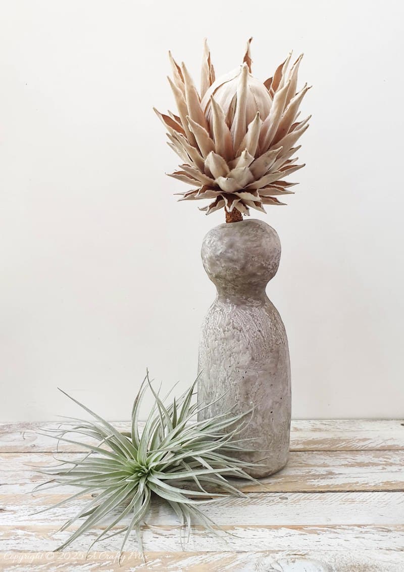 Make a delightful faux concrete bunny vase in under an hour using stuff you probably have lying around. This easy Easter craft is perfect for adding a touch of rustic elegance to your home decor. Use it to display long leaves for bunny ears or fill it with flowers for a beautiful centerpiece. It's a fun and creative way to welcome spring.