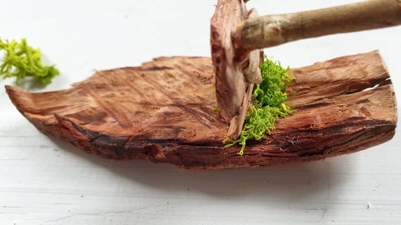 Glue small bits of moss onto the chair