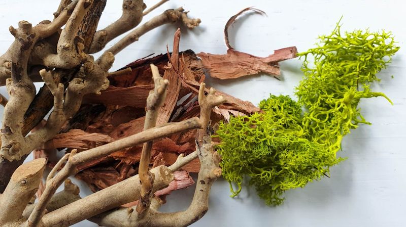 Simple materials including wood chips, twigs, and moss is all you need to make this little fairy chair