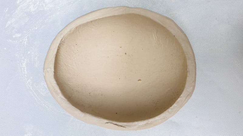 Use a garden pebble to form the spoon