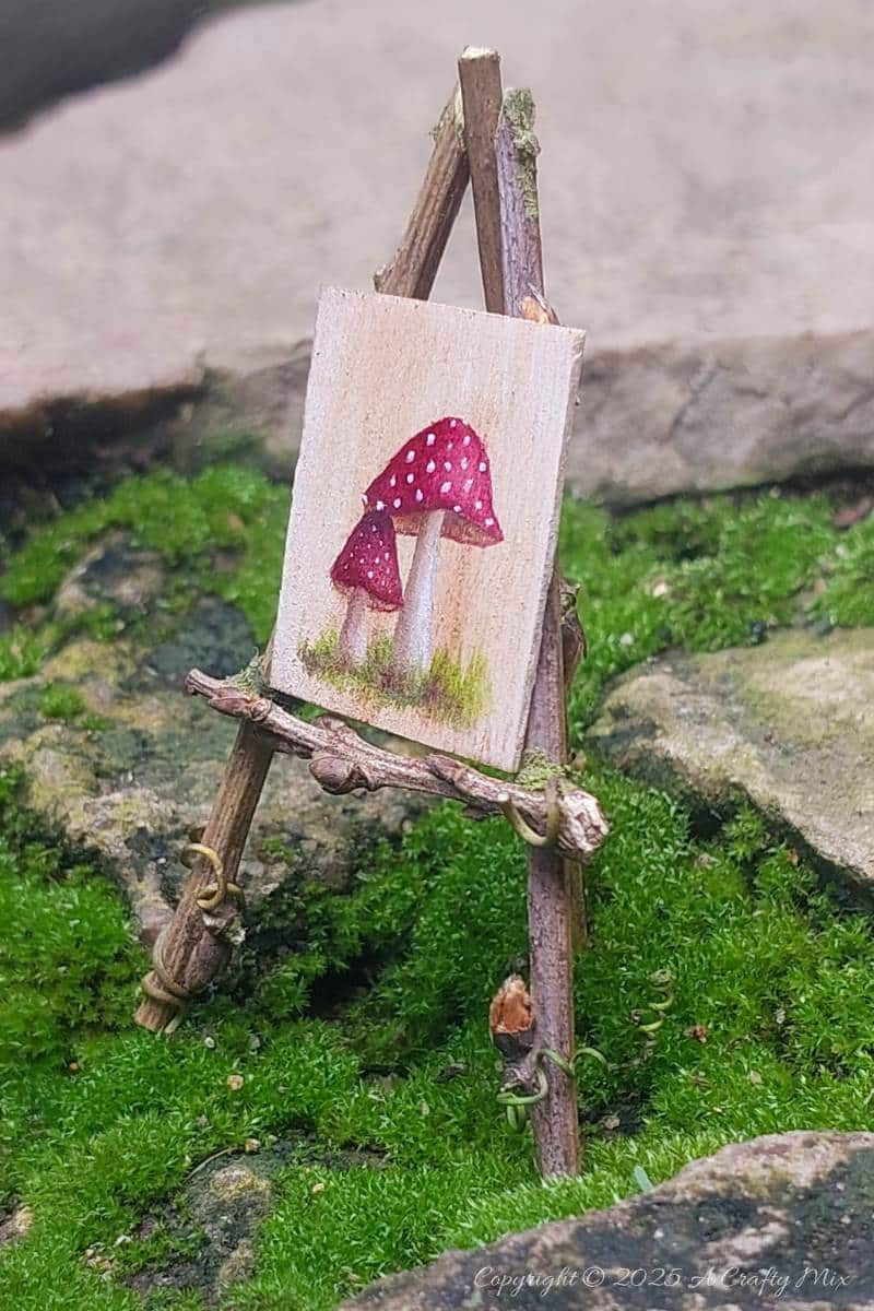 Make your own fairy easel and mini paintbrushes with this step-by-step tutorial. These charming little crafts are quick, easy and perfect for fairy gardens, dollhouse displays, or showcasing miniature art.