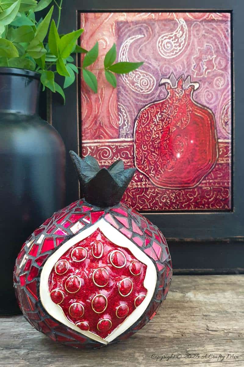 Love mosaics and want to try something new? This faux cloisonn&eacute; pomegranate combines bold mosaic tiles with glistening, wire-framed seeds for a show-stopping effect. No kiln needed&mdash;just creativity and a few craft supplies. Pin for your next DIY art adventure. 