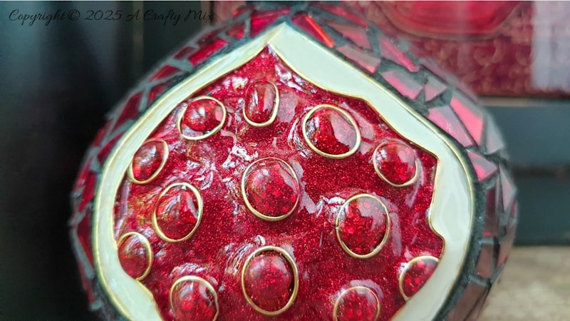 Love mosaics and want to try something new? This faux cloisonn&eacute; pomegranate combines bold mosaic tiles with glistening, wire-framed seeds for a show-stopping effect. No kiln needed&mdash;just creativity and a few craft supplies. Pin for your next DIY art adventure. 