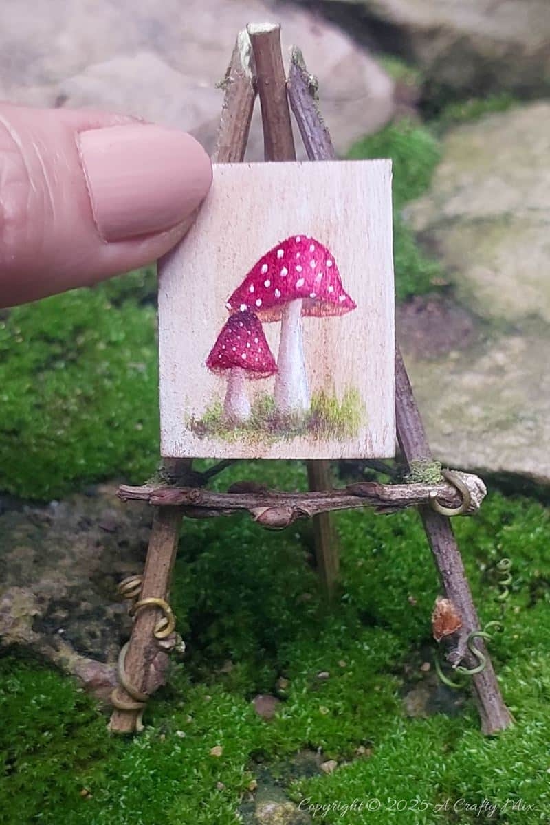Make your own fairy easel and mini paintbrushes with this step-by-step tutorial. These charming little crafts are quick, easy and perfect for fairy gardens, dollhouse displays, or showcasing miniature art.