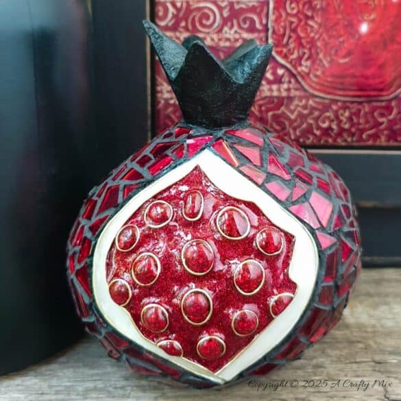 Love mosaics and want to try something new? This faux cloisonné pomegranate combines bold mosaic tiles with glistening, wire-framed seeds for a show-stopping effect. No kiln needed—just creativity and a few craft supplies. Pin for your next DIY art adventure. #fauxcloisonné #mosaic #pomegranate