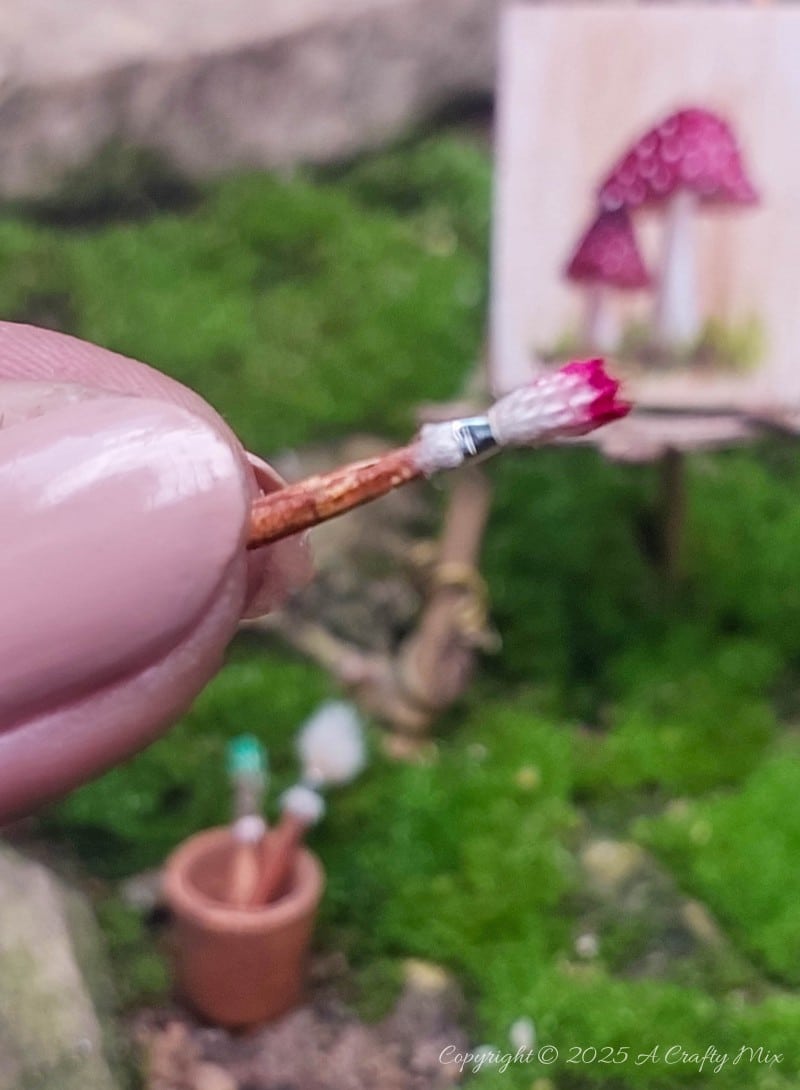 Make your own fairy easel and mini paintbrushes with this step-by-step tutorial. These charming little crafts are quick, easy and perfect for fairy gardens, dollhouse displays, or showcasing miniature art.