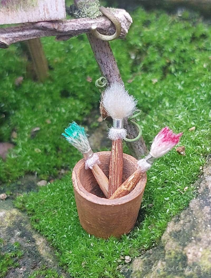 Make your own fairy easel and mini paintbrushes with this step-by-step tutorial. These charming little crafts are quick, easy and perfect for fairy gardens, dollhouse displays, or showcasing miniature art.