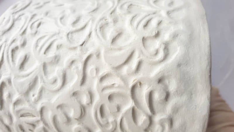 The vintage embossed container after the clay has cured