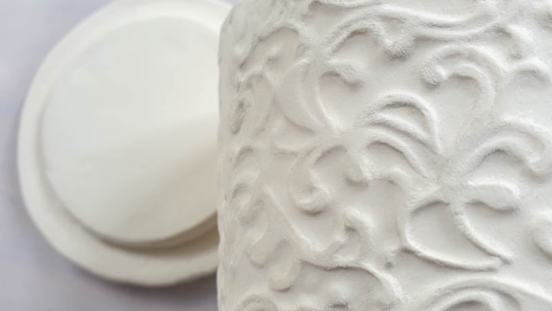 A view of the vintage embossed container and lid before painting