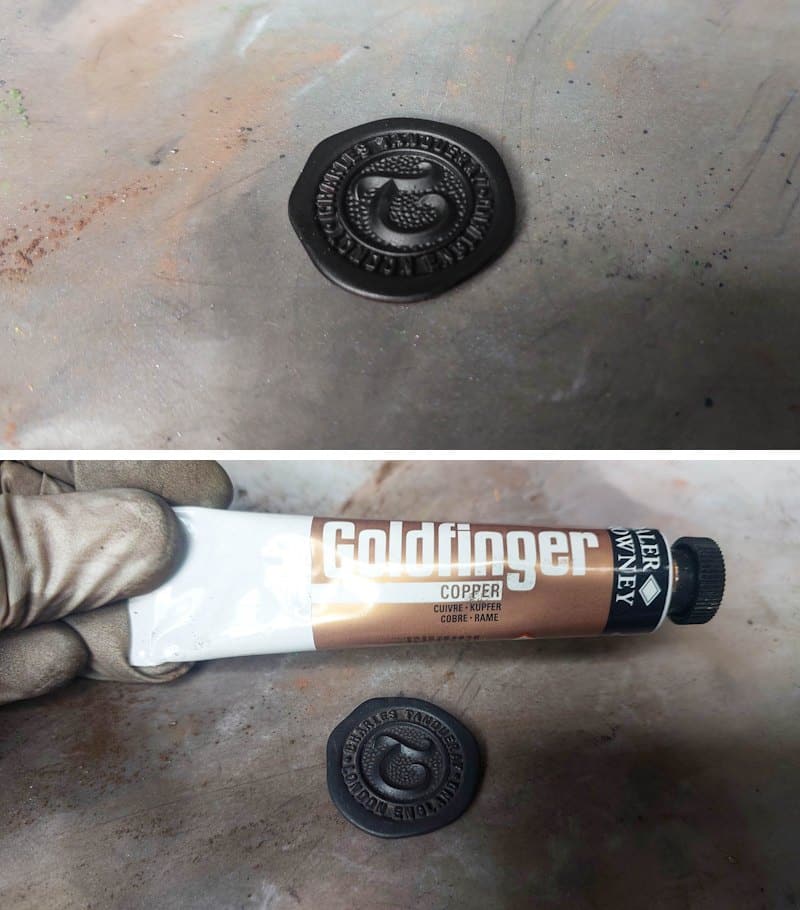 Highlight the details on the stamp with bronze or copper rub and buff