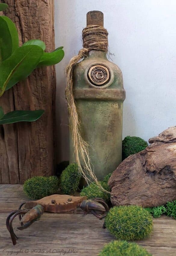 Upcycle ordinary bottles into old world treasures with this easy DIY. This beginner-friendly tutorial teaches you how to create an authentic antique clay finish using simple powdered food coloring and texture paste. Perfect for rustic or old-world décor.