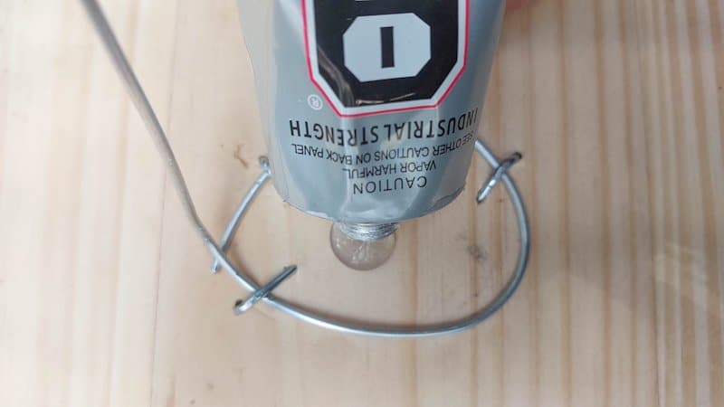 Glue the witch's feet over the wire