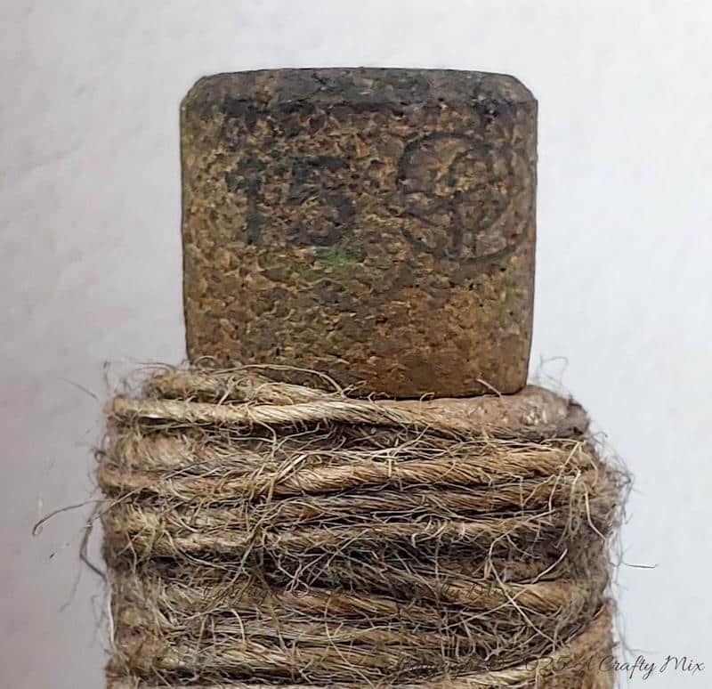 Upcycle ordinary bottles into old world treasures with this easy DIY. This beginner-friendly tutorial teaches you how to create an authentic antique clay finish using simple powdered food coloring and texture paste. Perfect for rustic or old-world d&eacute;cor.