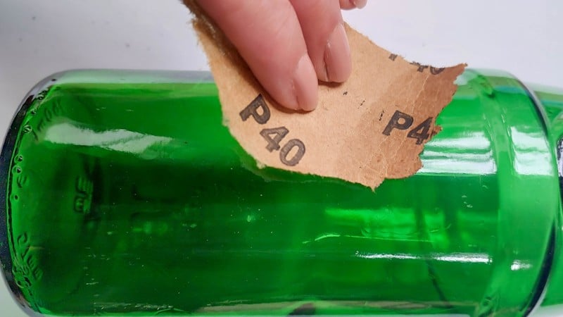 Sand the bottle with 40 or 60 grit sandpaper.