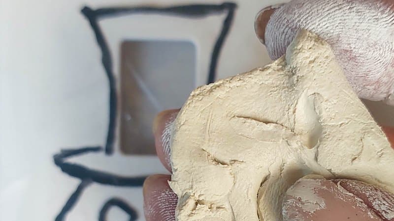 Condition the clay between your fingers to soften it up.