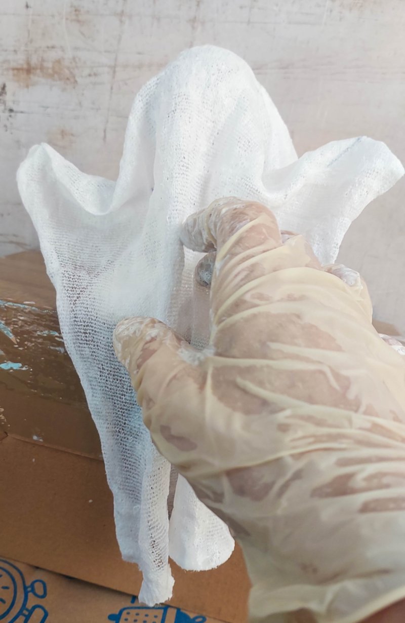 Drape the fabric over the ghost skeleton or frame