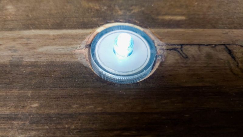 A view of the tea light inside the hole in the swing