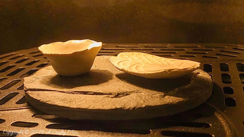 Two small clay creations in an air fryer
