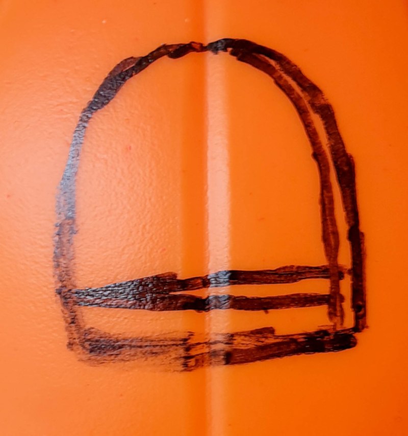 Cut a window in the plastic pumpkin bucket
